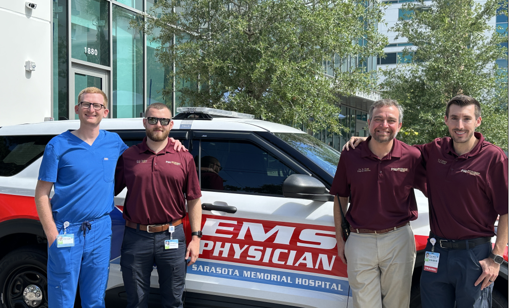 Dr. Frank and Fellows by EMS Vehicles