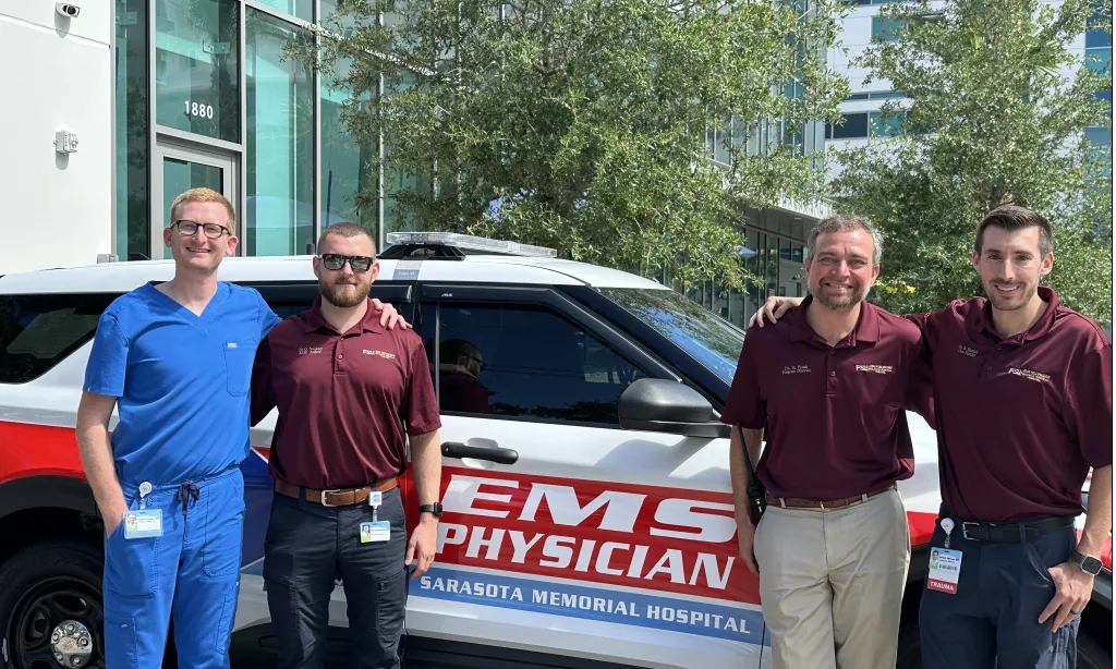 GPN EMS physicians beside a Sarasota Memorial EMS Physician vehicle
