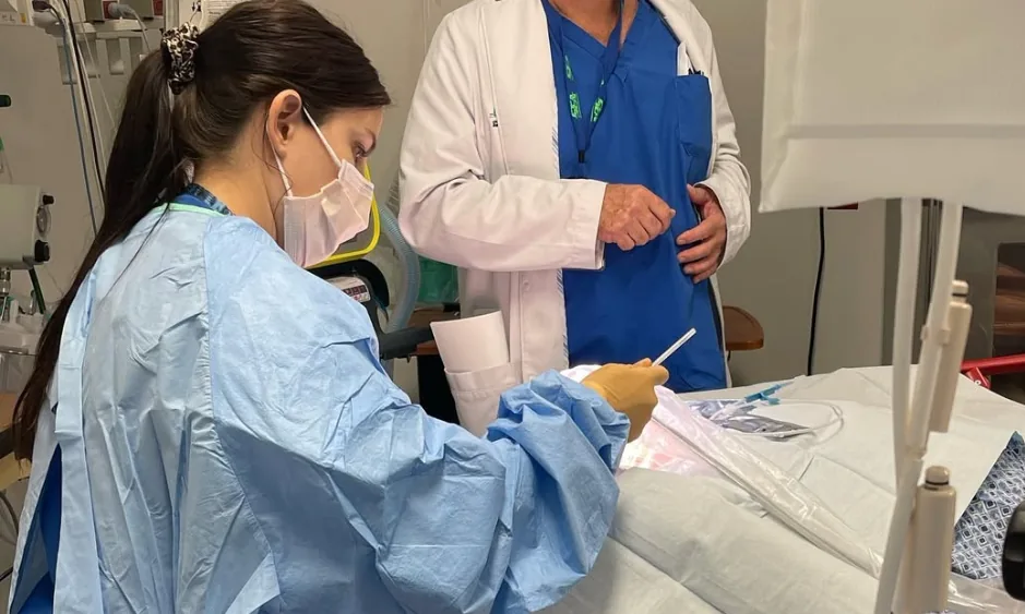Physicians performing a procedure at the bedside